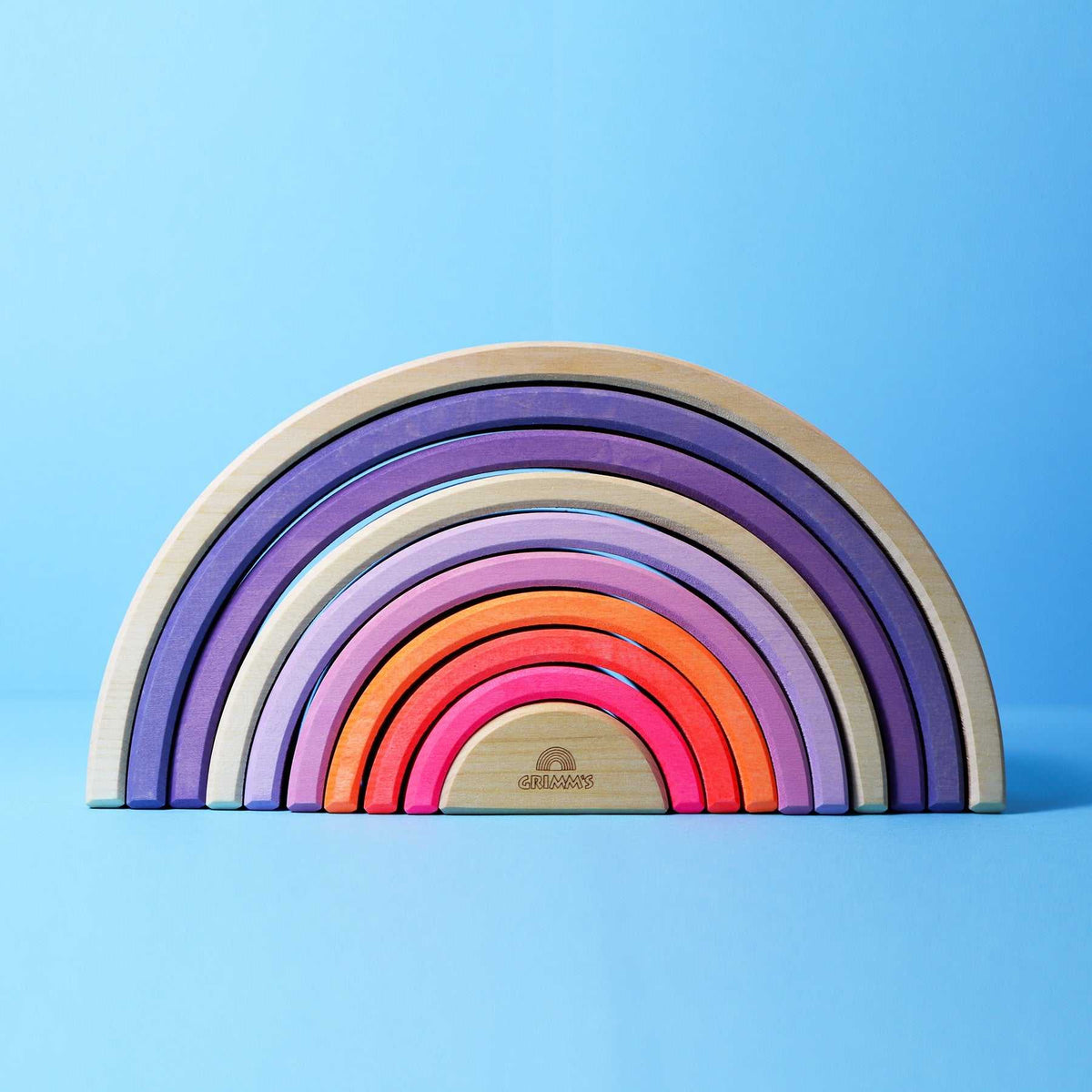 Neon pink 10-piece wooden Regenbogen toy by Grimms with vibrant stacking arches