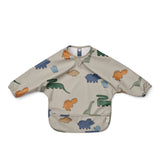 Liewood Lätzchen Merle Dinosaurier mit Ärmeln, Auffangbeutel und Druckknopfverschluss in Dino-Design